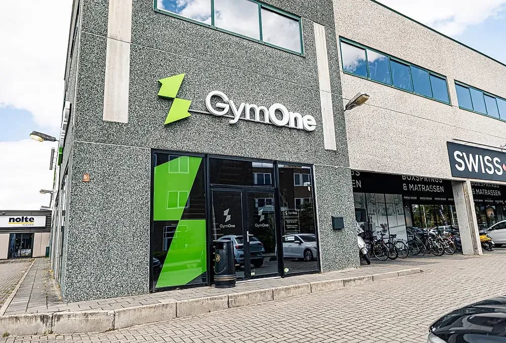 Gevel van GymOne Enschede met GymOne-logo en entree aan de straatzijde